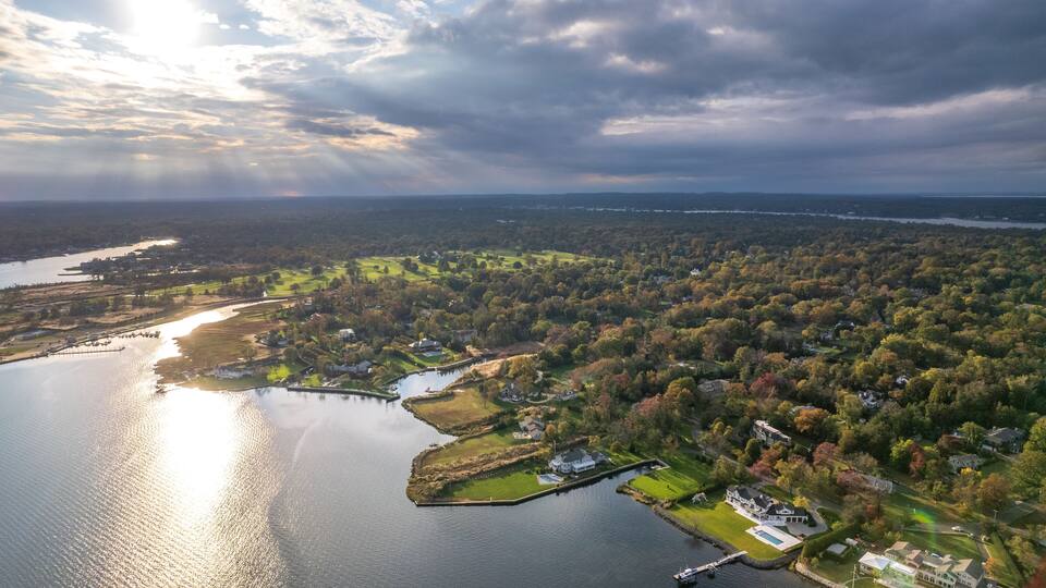 A lake surrounded by residential areas and dense forest.