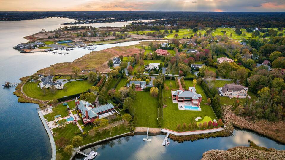 A lakeside community with houses, a dock, and a golf course.