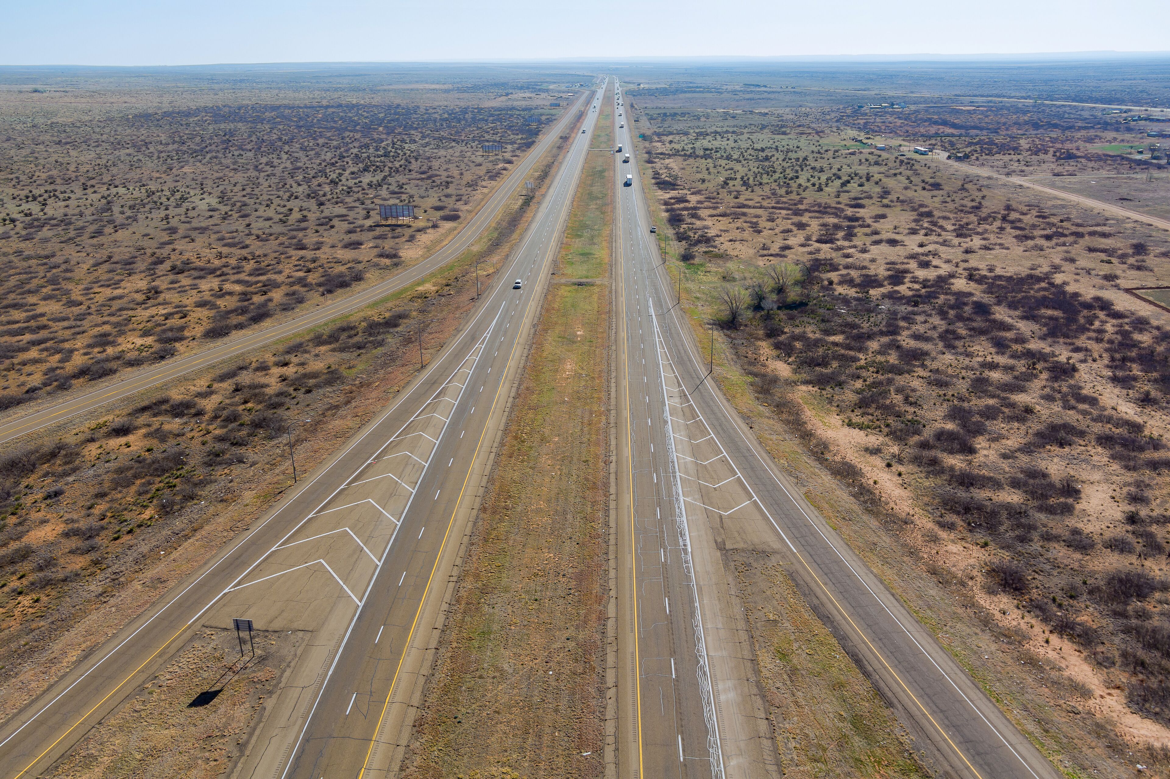 A highway with multiple lanes extending through a desert landscape.