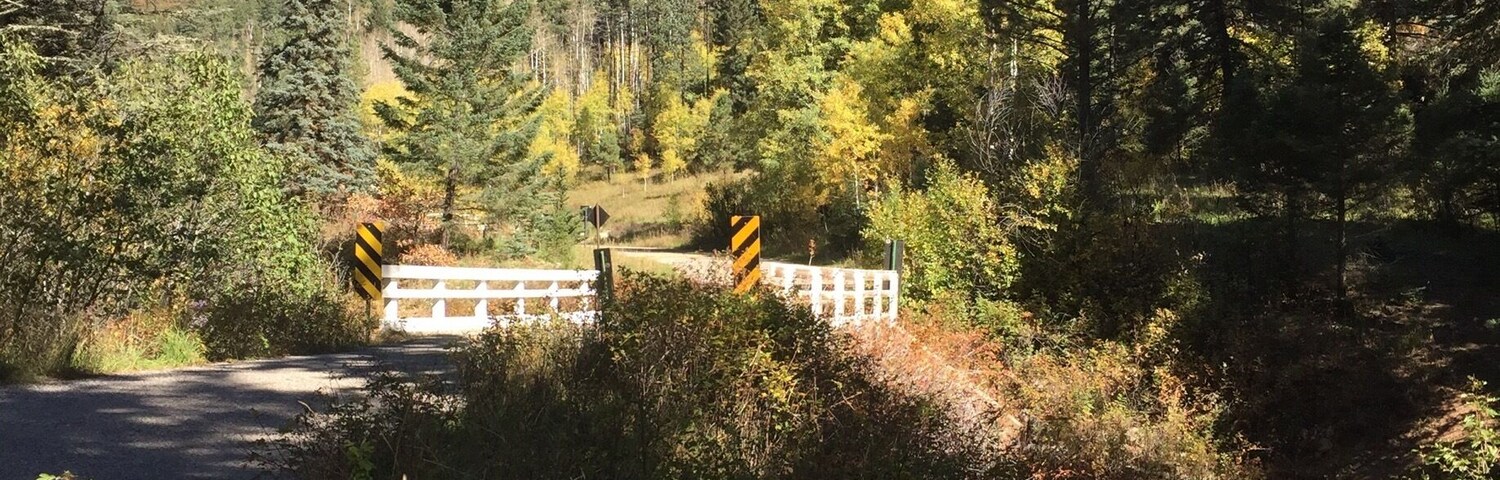 Open bridge crossing a Pecos River tributary that takes you through the Holy Ghost Campground in the Pecos National Wilderness.