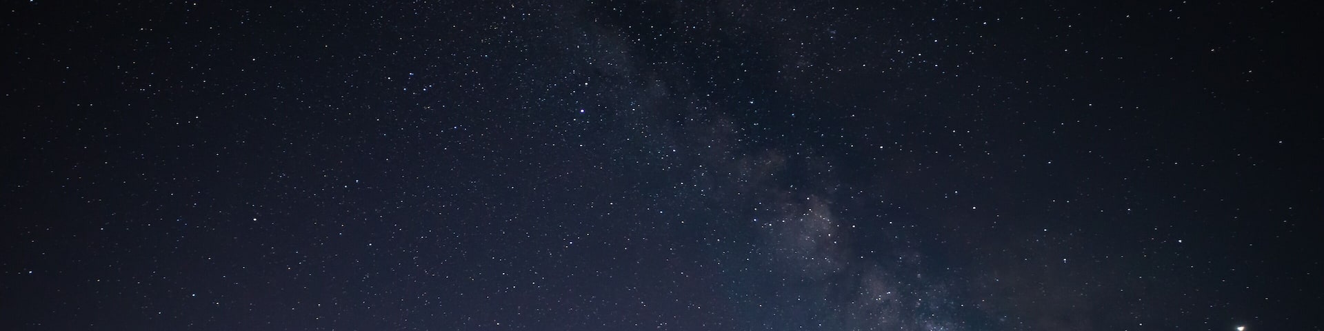 Milky Way photographed on clear sky night near a wind farm