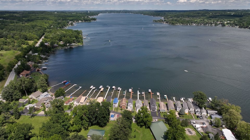 A large lake with a marina, surrounded by residential areas and dense forests.