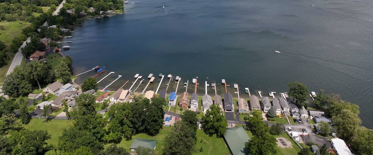 A large lake with a marina, surrounded by residential areas and dense forests.