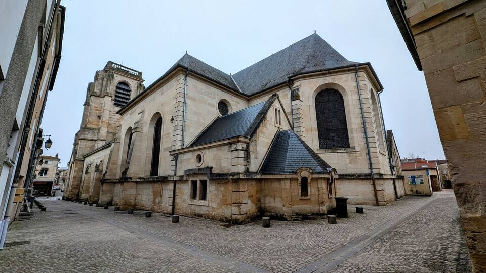 A historic stone church with a steeply pitched roof and a bell tower.