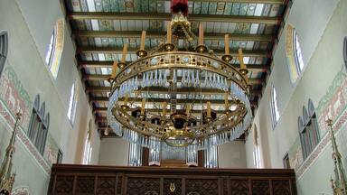 An ornate chandelier with a red tassel hanging from the ceiling.