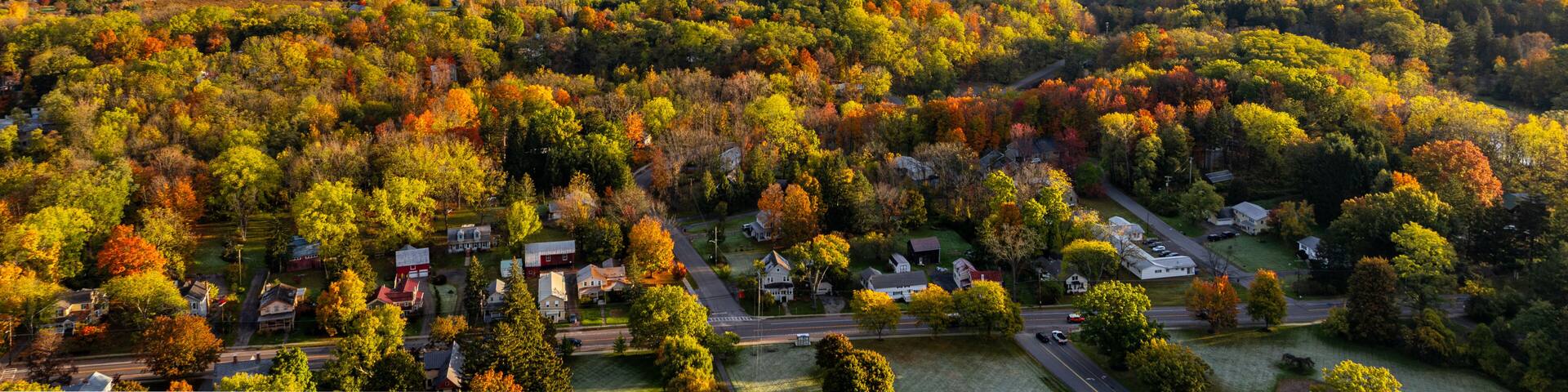 Trumansburg, NY, USA - October 17, 2025: Aerial photo over the Village of Trumansburg, NY with view of Cayuga Lake