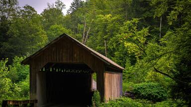 Brown Covered Bridge, built in 1880, spans the Cold River in Shrewsbury, Vermont, nestled in a wooded ravine and honored as a National Historic Landmark
