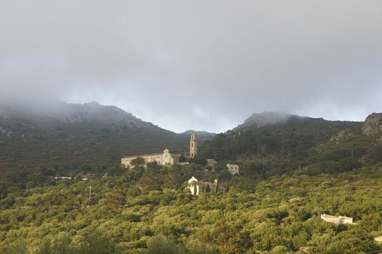 Pigna, Corsica is surrounded by misty mountains just before sunset.

#corsica #roadtrip