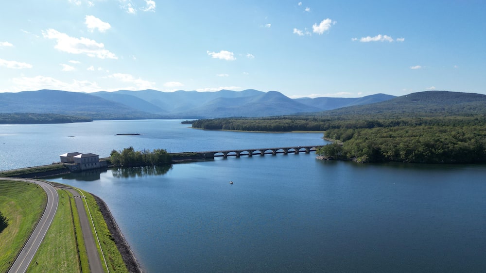 aerial view of the ashokan reservoir in upstate new york (near woodstock olivebridge) nyc drinking water and catskill mountains (catskills hills background) park road walkway bridge crossing lake pond