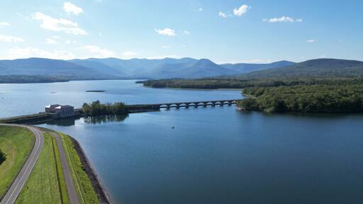 aerial view of the ashokan reservoir in upstate new york (near woodstock olivebridge) nyc drinking water and catskill mountains (catskills hills background) park road walkway bridge crossing lake pond