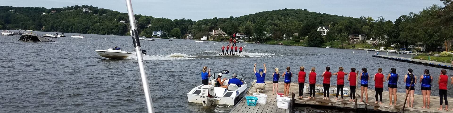 American Flag Blowing in the Wind with a Lake and Boating Background; Travel and Vacation Destinations; American Culture