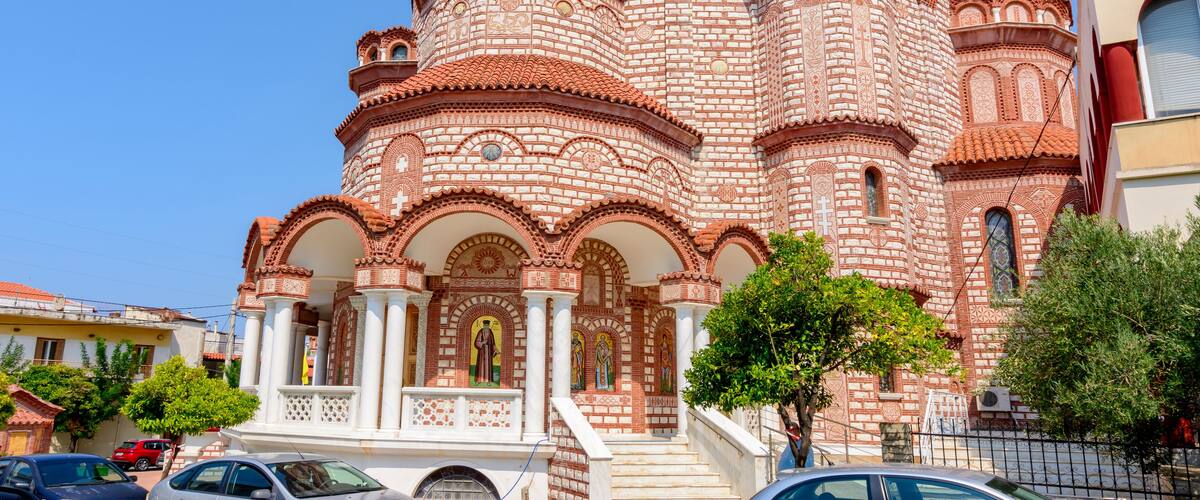 A large, ornate church with multiple domes and intricate brickwork.