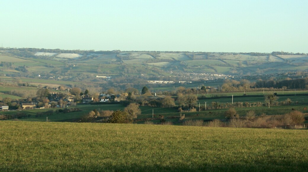 East of north from Tunley Road As it approaches Tunley from the east the B3115 follows the top of a ridge giving views to the north and south on a clear day. Here we look north to Lansdown, the racecourse is just beyond the horizon. If you are looking for Kelston Round Hill it is dead centre frame well camouflaged against the background, its clump of trees only just clears the skyline. ST7167 Upper Weston is beneath Lansdown Hill to the right and nearer the camera we find bits of Inglesbatch and Priston.