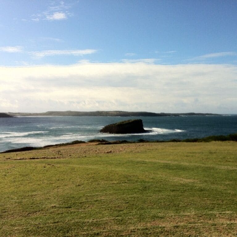 Small rocky island off headland