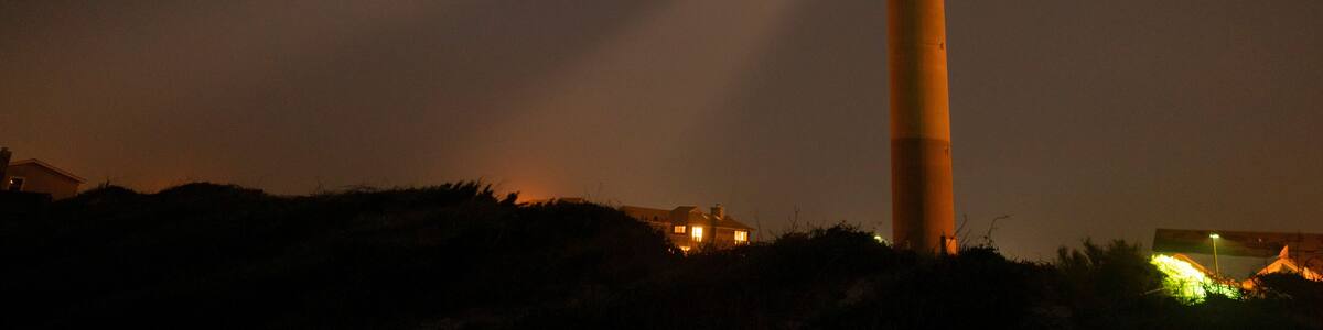 Oak Island Lighthouse Beams into the Seafoam at Fort Caswell