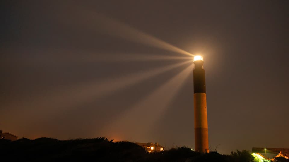 Oak Island Lighthouse Beams into the Seafoam at Fort Caswell