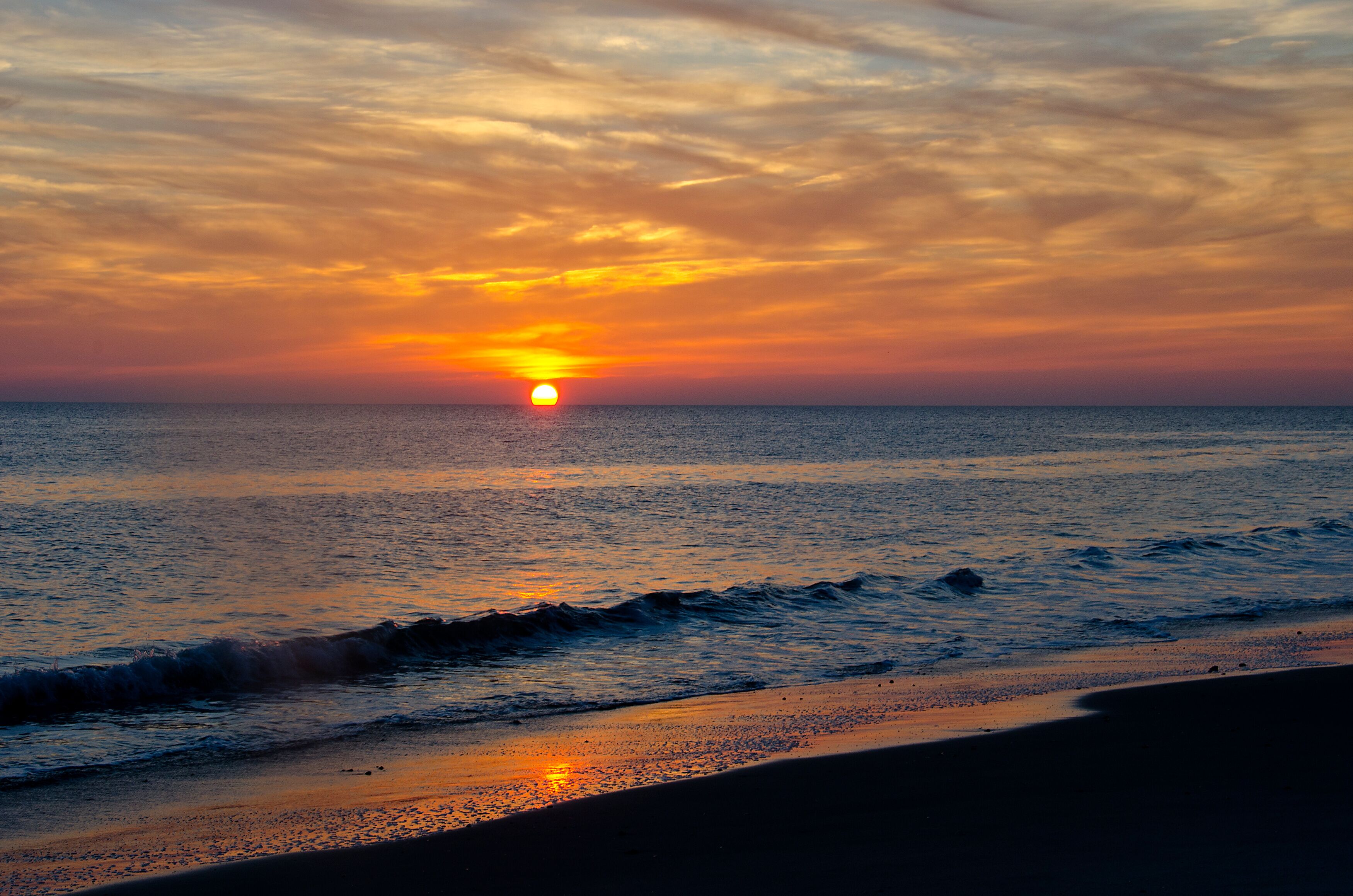 Sun Dips Below Horizon on the Beach