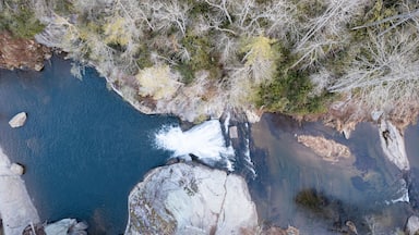 A river flowing through a rocky landscape with sparse vegetation.
