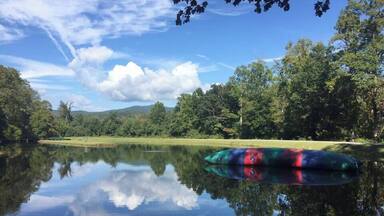 The lake is still in this picture, but soon it will be filled with kids swimming, canoeing, kayaking and BLOBBING at Camp Highlander in North Carolina. #LifeAtExpediaGroup