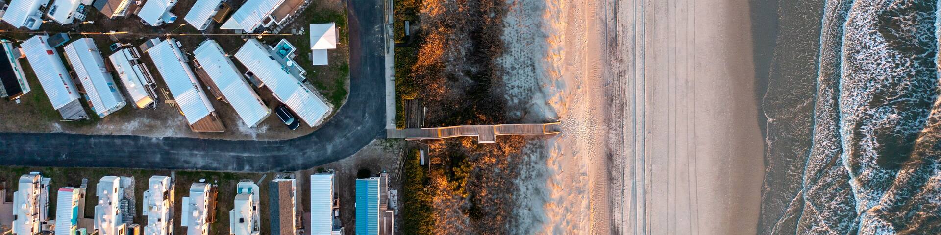 Top Down Aerial View of a Trailer Park on the Beach with Access and the Atlantic Ocean at Sunset