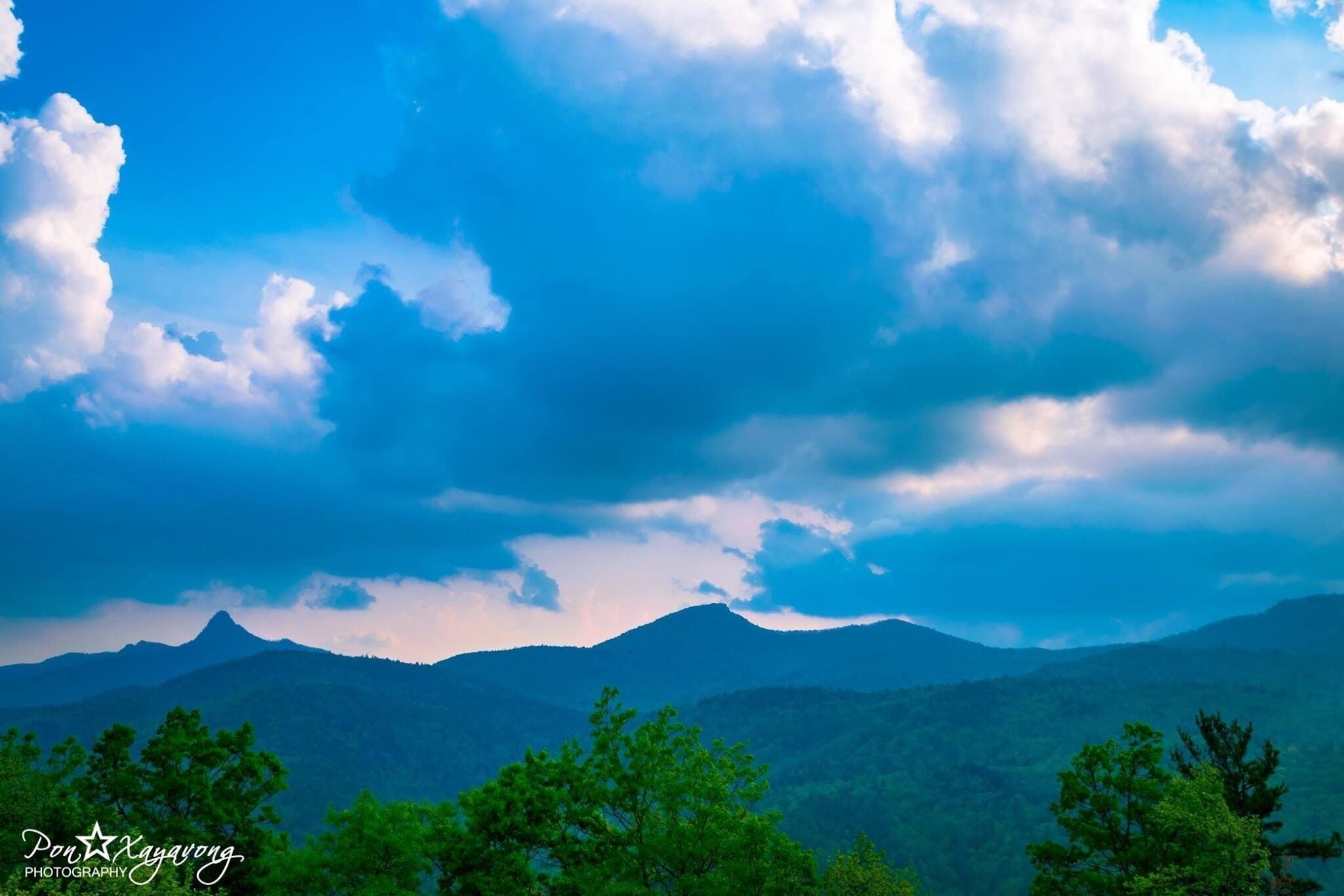 A mountain range with a cloudy sky.
