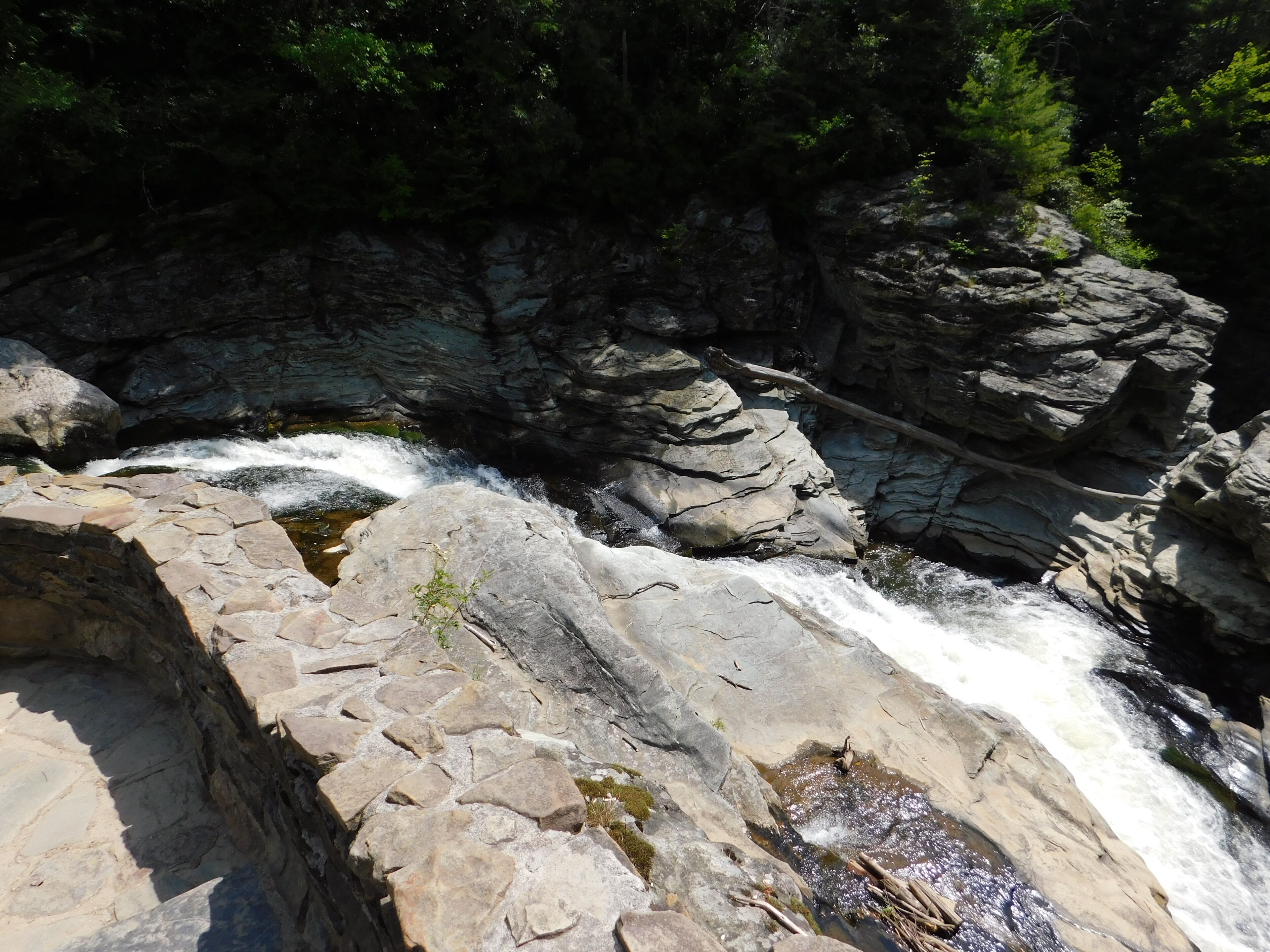 A rocky waterfall with clear water flowing over the rocks.