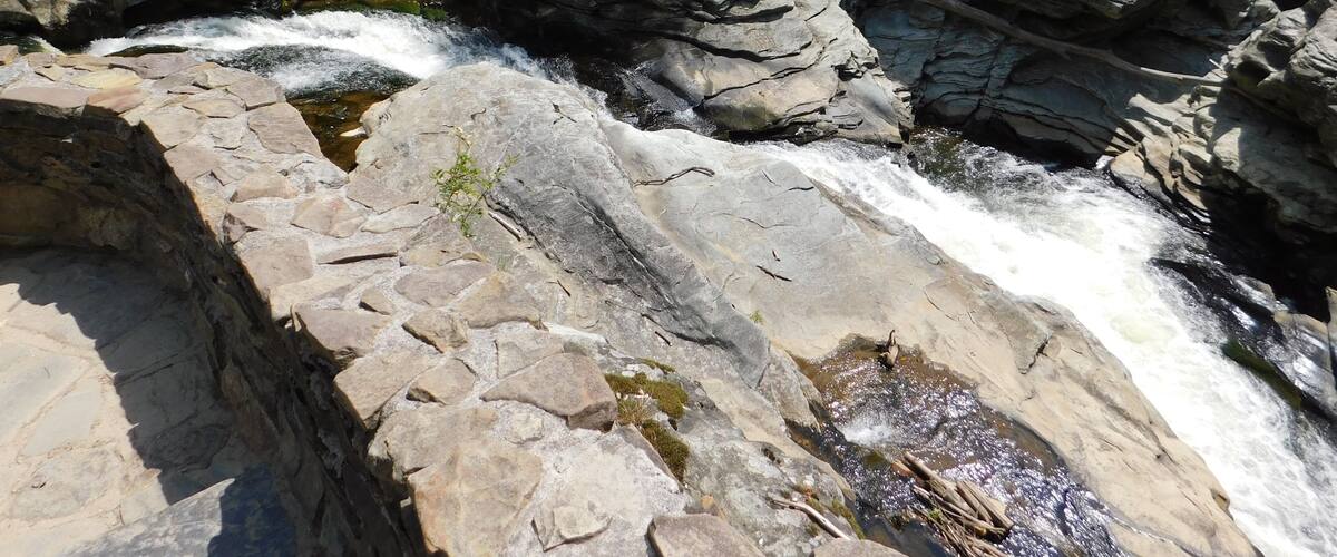 A rocky waterfall with clear water flowing over the rocks.