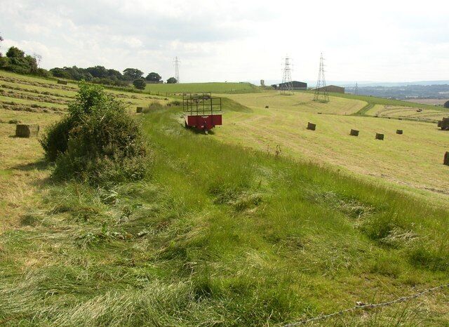 The navigation bank, southern part, Birkenshaw There is no right-of-way along the southern part. It has been preserved between two hayfields. It curves around the hillside and ends near some spoil heaps at Blue Hills Farm.