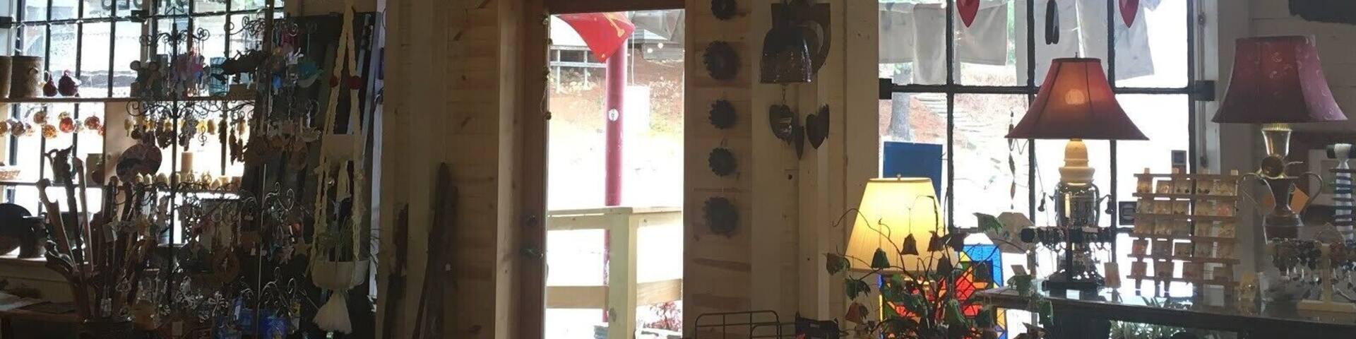 The interior of the One of A Kind (OOAK) art gallery in Micaville, NC. With a slogan of “fine, folk, and funky”, this place embodies Appalachian art and culture-- down to the very building it stands in. When Micaville was a mining town, this building was the general store. Through the years, the “Robinson General Merchandise” sign and painted windows have remained mostly untouched, which provides a unique and rare frame of this location through time. The new framed alongside the old emphasizes that Appalachia holds strong to tradition and legacy. #appalachianechoes