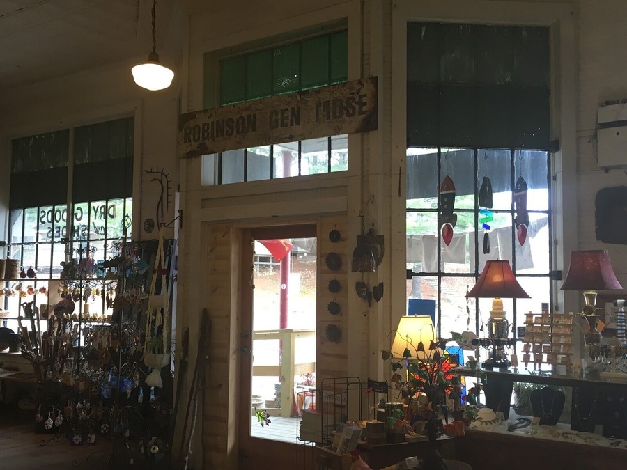 The interior of the One of A Kind (OOAK) art gallery in Micaville, NC. With a slogan of “fine, folk, and funky”, this place embodies Appalachian art and culture-- down to the very building it stands in. When Micaville was a mining town, this building was the general store. Through the years, the “Robinson General Merchandise” sign and painted windows have remained mostly untouched, which provides a unique and rare frame of this location through time. The new framed alongside the old emphasizes that Appalachia holds strong to tradition and legacy. #appalachianechoes