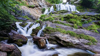 Long exposure shot of a beautiful waterfall flowing down the mossy rocks