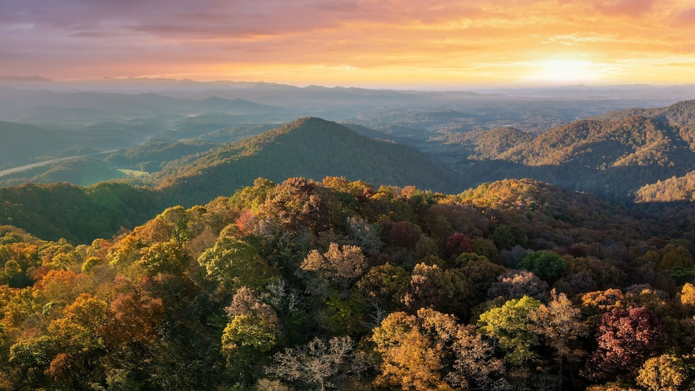 A mountainous landscape with autumn foliage.