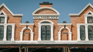 A brick building with the sign "NOLANSBLOCK" above the entrance.