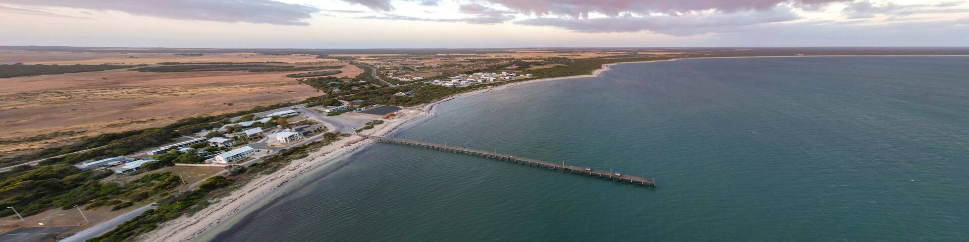 Aerial view of marion bay jetty at sunset with beautiful ocean and scenic shoreline, yorke peninsula, australia.