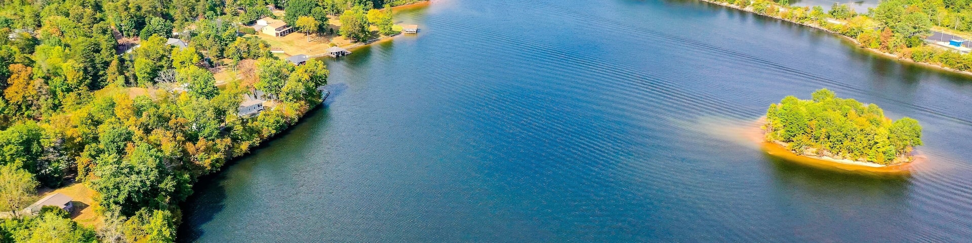 Aerial shot of Belews Lake in North Carolina, USA with a small island, houses, powerplant