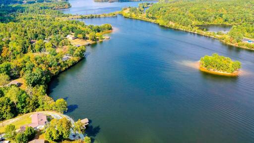 Aerial shot of Belews Lake in North Carolina, USA with a small island, houses, powerplant