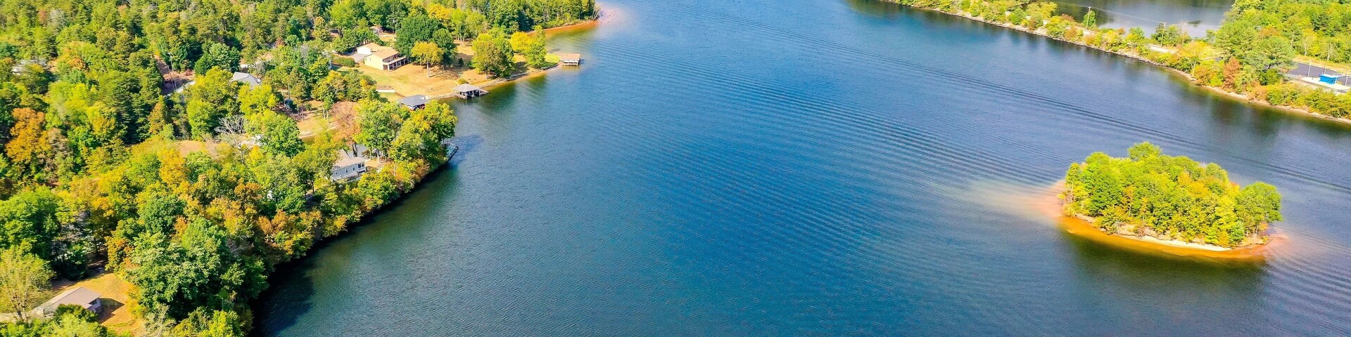 Aerial shot of Belews Lake in North Carolina, USA with a small island, houses, powerplant