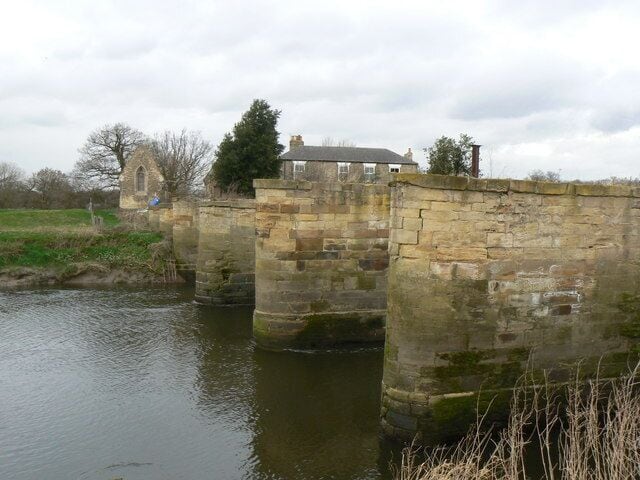 Piers of an earlier Bridge These derelict piers are all that remain of an earlier bridge over the River Aire at Snaith. The buildings in the back ground form part of Bridge Farm.