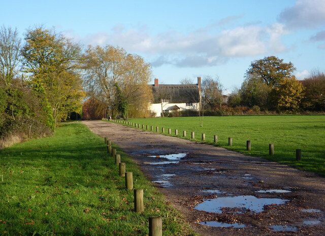Track by the village green The track leads to a few houses, soon becoming a footpath across the fields turning north to Middlewood Green. The A1120 is not far off the picture to the right.