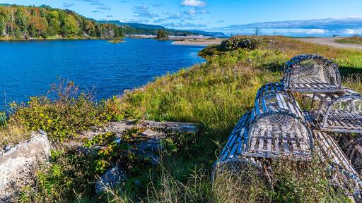 A view past lobster pots along the MacDonalds pond at the Little River on the Cabot Trail, Nova Scotia, Canada in the fall