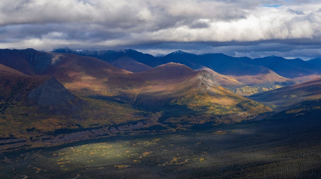 Stunning aerial view of the Ruby Range under heavy clouds near Destruction Bay, with autumn setting in on the Yukon landscape; Destruction Bay, Yukon, Canada