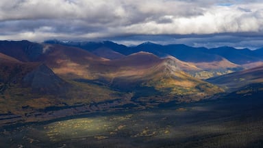 Stunning aerial view of the Ruby Range under heavy clouds near Destruction Bay, with autumn setting in on the Yukon landscape; Destruction Bay, Yukon, Canada