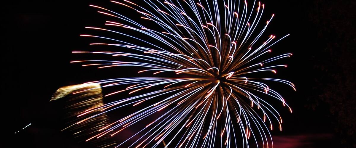 A firework display with a dark background and bright, colorful trails.