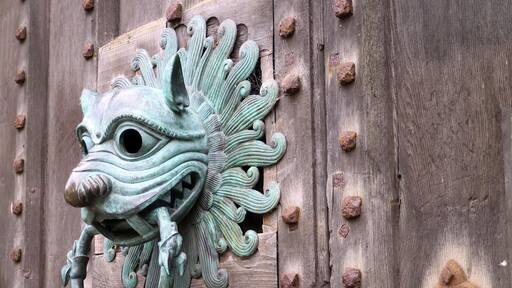 Knocker on door with sanctuary ring