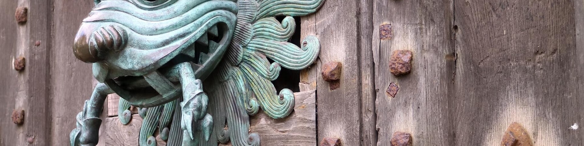 Knocker on door with sanctuary ring