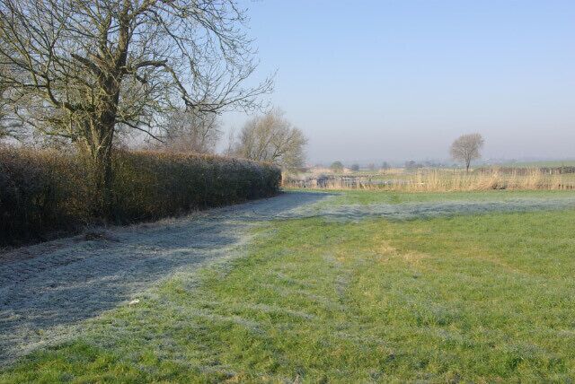 Farmland near Church Lawford Looking down the broad Avon Valley from Kings Newnham Road, just north of Church Lawford village on a cold morning; the frost is melting where it is exposed to the sun.
