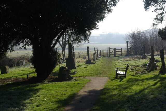 Church Lawford Churchyard A public footpath passes through the churchyard of St Peter's Church, by the seat and through the kissing gate beyond.
