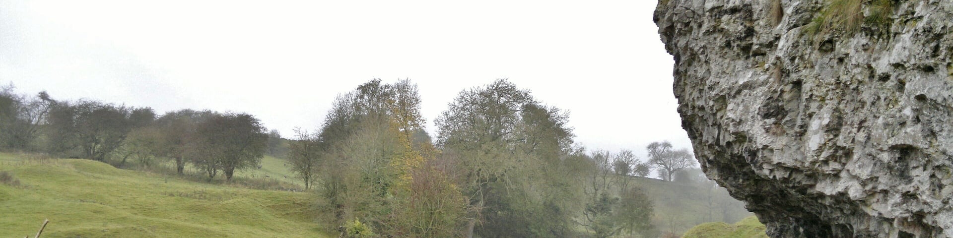 Harold Gee's bench beneath the rock overlooking the packhorse bridge over the River Bradford near Bradford, near Youlgreave, Derbyshire