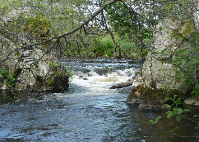 Errochty Water goes through stone gateway Two huge boulders funnel the river through narrow rapids shortly before it joins the River Garry.