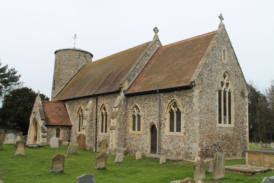 The round tower is definitely Saxon in origin, approximately 950 years old, and has a triangular headed doorway on the first stage above the tower arch inside the church and is constructed with some large puddingstone material near the base inside. The thickness of the flint walls is less than that of a Norman builder. It has Saxon belfry windows constructed with flat flints set to make a round topped opening. The bottom one on the west face is a modern one made to match the others. The tower is capped with a lead roof but at one time would have been tiled. The base of the tower is 6 inches thicker up to a height of 10 feet. During the 1797 restoration the church was described as “the aspect of a gloomy moss grown cavern” being changed into “a decent place of public worship”. During this restoration the north aisle and south porch were demolished and the east window was opened up. The chancel floor was also raised at this time and new seats added. At the 1855 and 1898 restorations the north aisle was rebuilt and the Norman parts of the north doorway returned to their former position. The south porch was rebuilt and a vestry added. The present pews were installed in 1898. The chancel arch is from the Perpendicular period and the wrought iron screen and modern rood were added in 1932. Pic by Jenny.